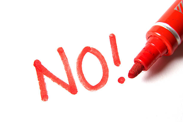 The word 'NO!' written in red marker on a white background.